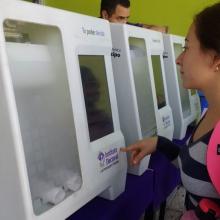 Mujer realizando su voto en urna electrónica